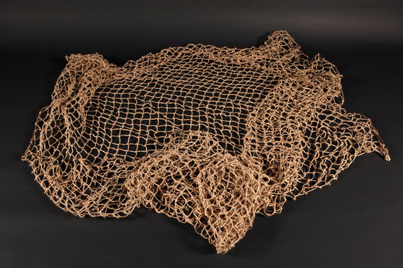 Replica of a fishing net made from vegetable fibres.