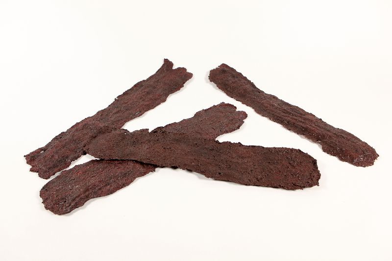 Replicas of four strips of beef jerky.